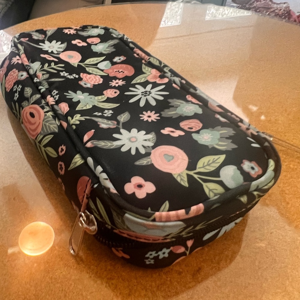 20% off listed price Makeup case. Zipper closure. Black with floral design